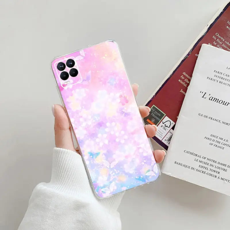 a person holding a phone case with a pink and blue marble pattern