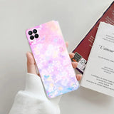 a person holding a phone case with a pink and blue marble pattern