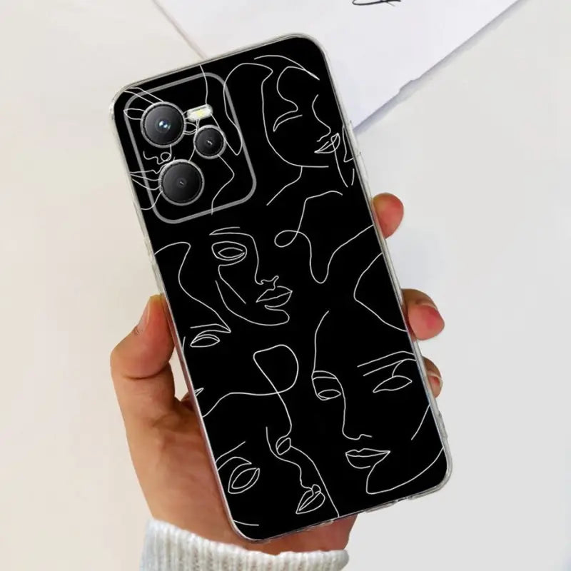 a person holding a phone case with a black and white drawing of a face