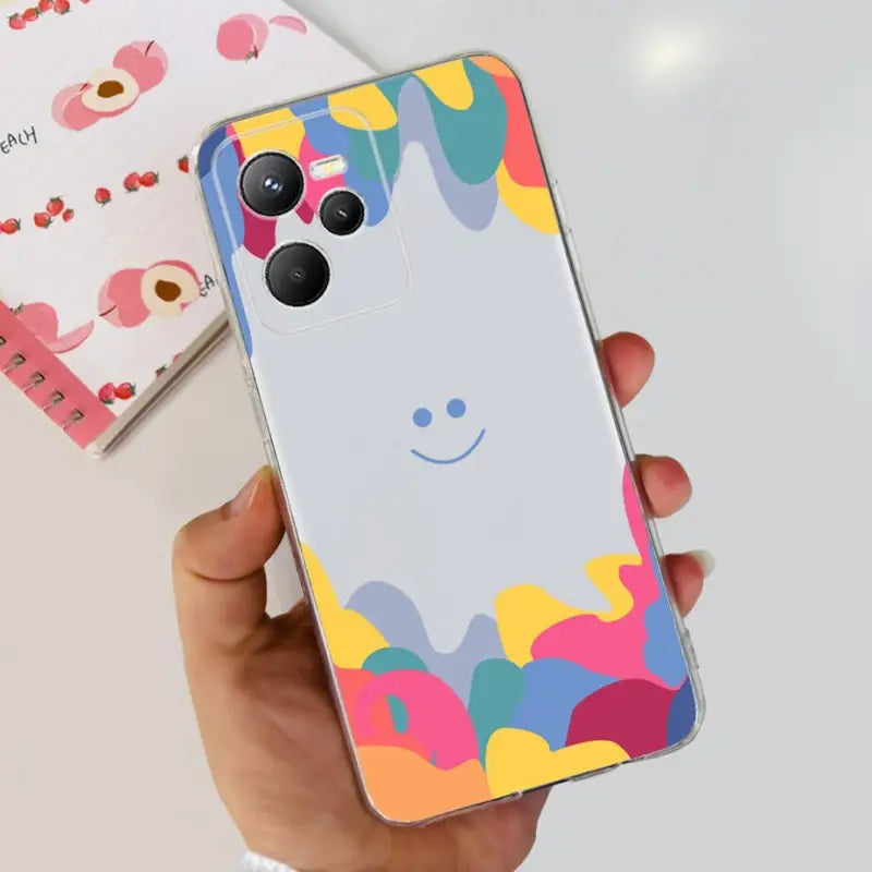 a person holding a phone with a colorful pattern on it