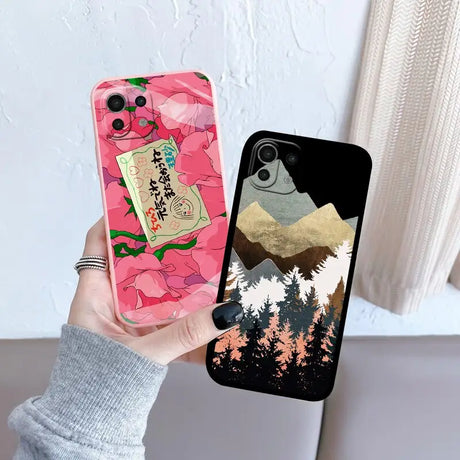 a person holding up a phone case with a mountain scene