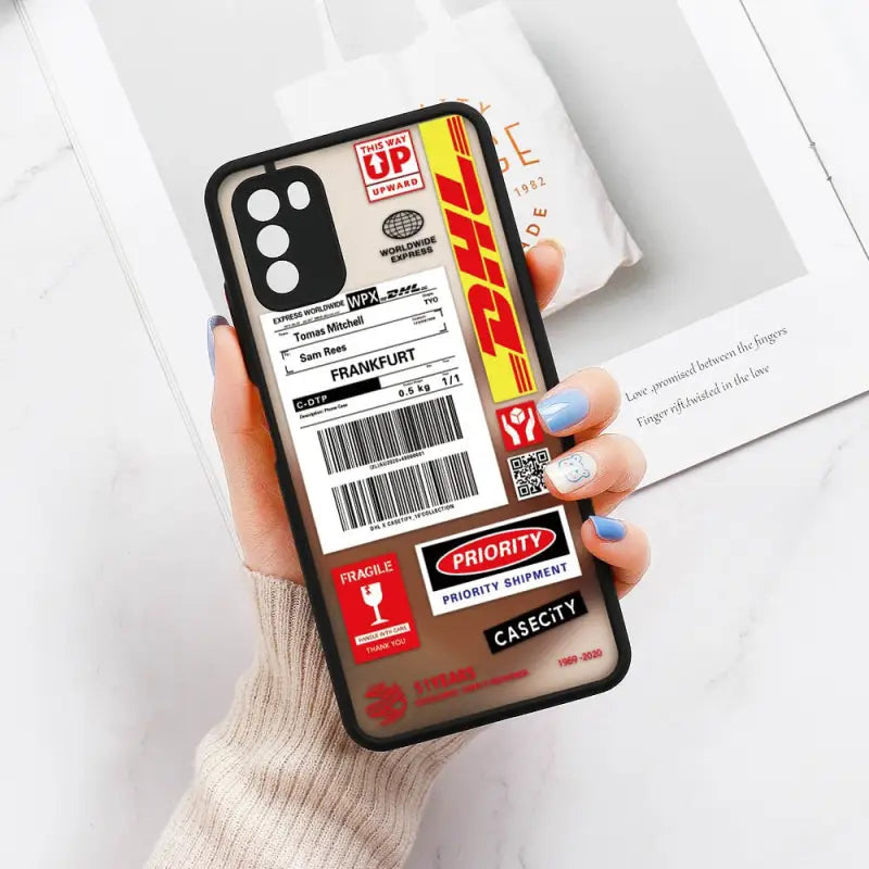 a person holding a phone case with a barcode sticker on it