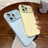a person holding a phone case on a table