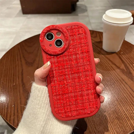 a person holding a red phone case