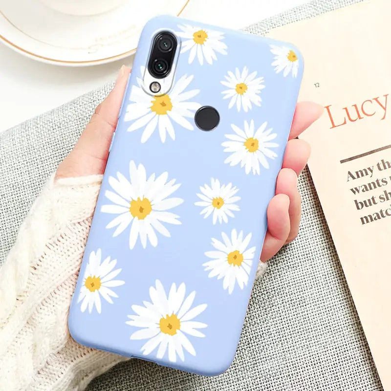 a person holding a phone case with a flower pattern on it