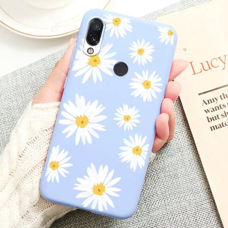 a person holding a phone case with a flower pattern on it