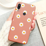 a close up of a person holding a phone with a flower pattern on it