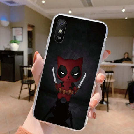 a close up of a person holding a phone case with a deadpool on it