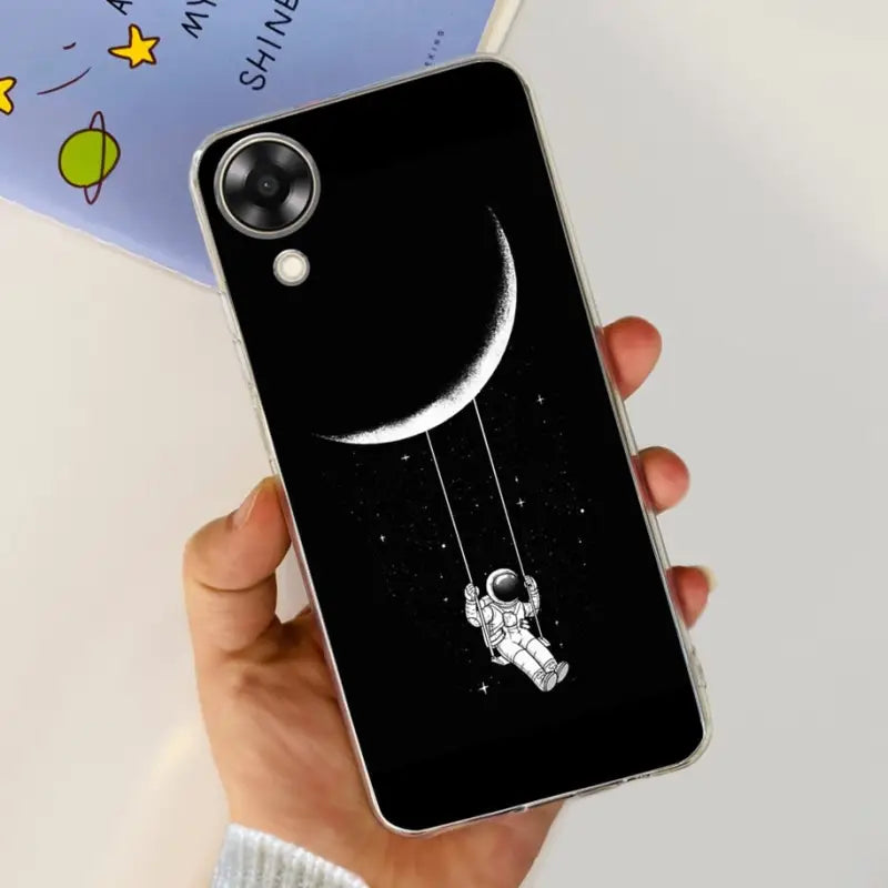 a person holding a phone case with a drawing of an astronaut on it