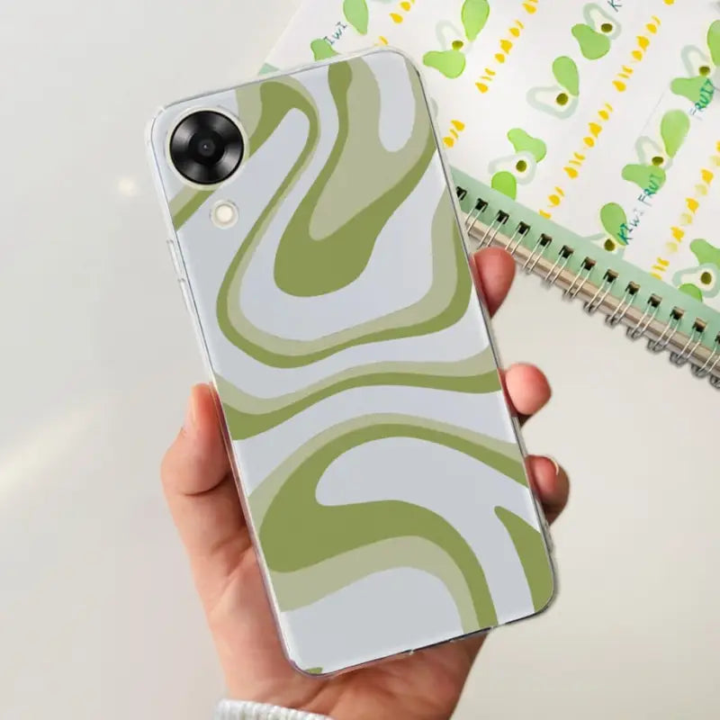 a person holding a phone case with a green and white pattern