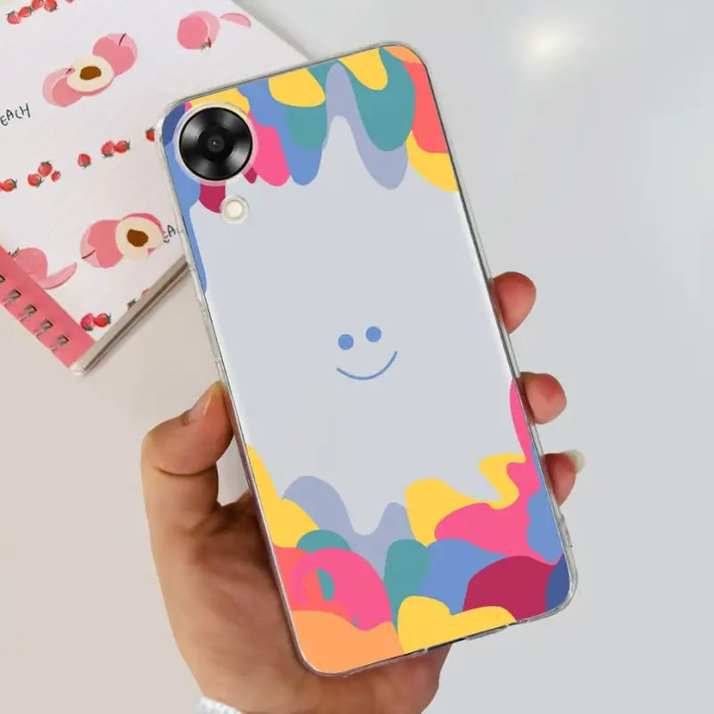 a person holding a phone case with a colorful pattern