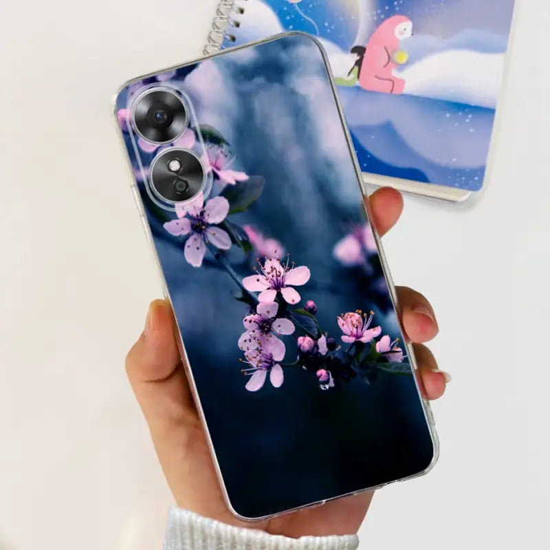 a person holding a phone with a purple flower on it