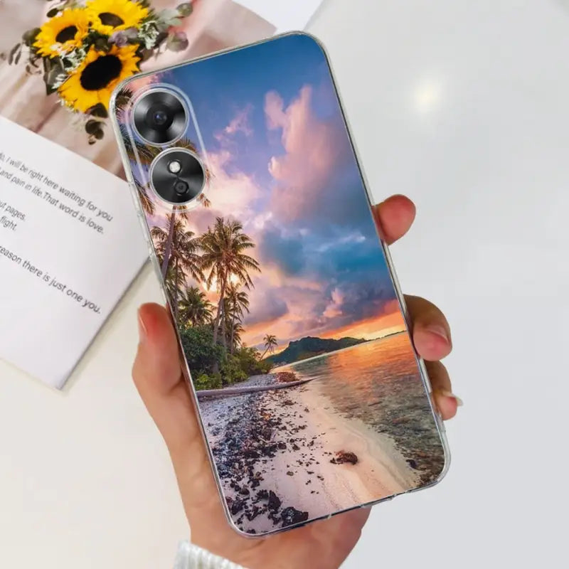 a person holding a phone with a sunset photo on it