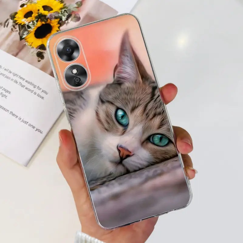 a woman holding a phone case with a cat on it