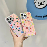 a person holding a phone case with a colorful polka dot pattern