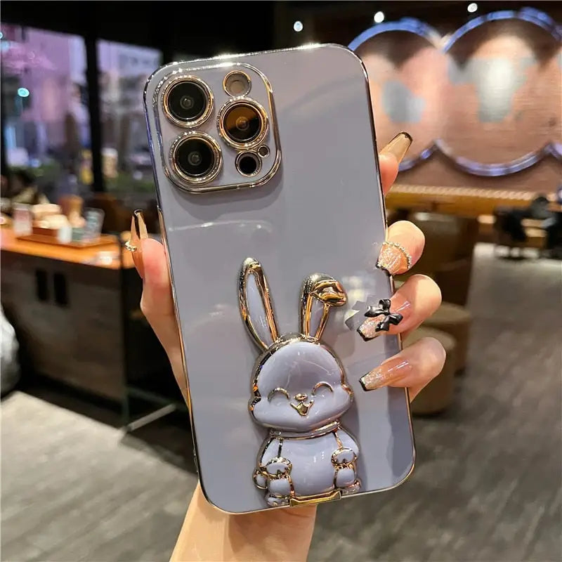a person holding a phone case with a small animal on it
