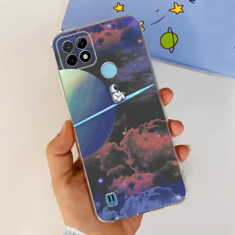 a person holding a phone case with a space theme