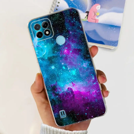 a person holding a phone case with a galaxy design