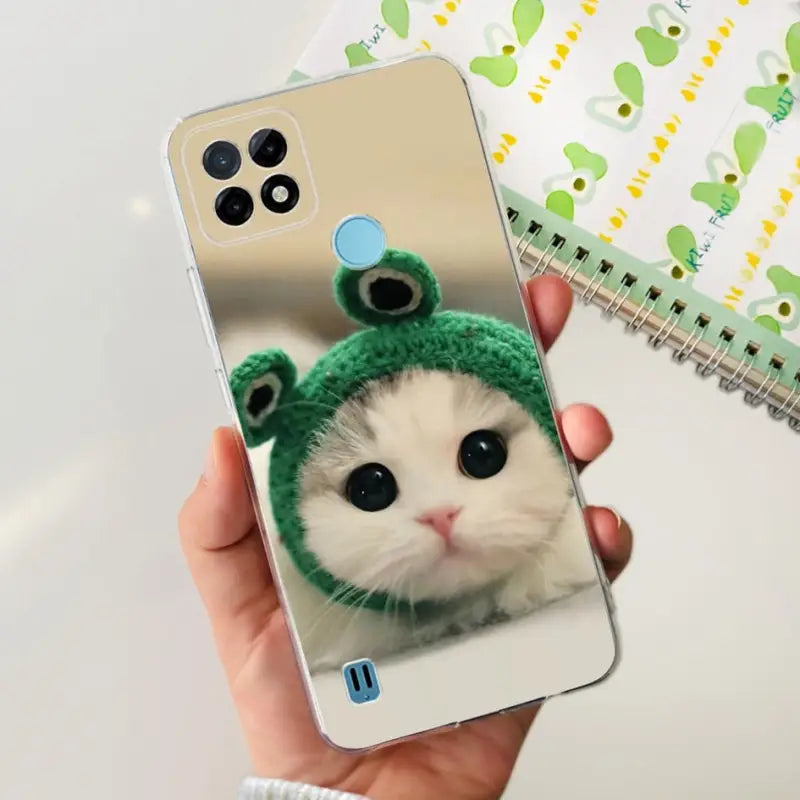 a person holding a phone with a cat in it