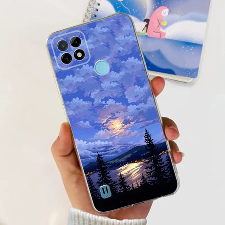 a person holding a phone case with a painting of a sunset