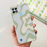 a person holding a phone case with a camouflage pattern