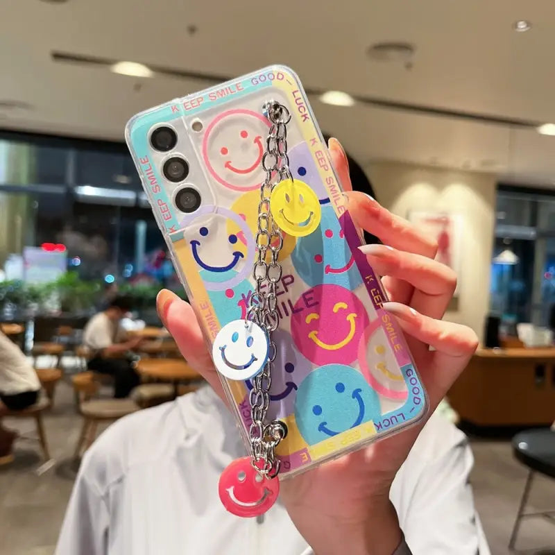 a person holding up a phone case with a colorful pattern