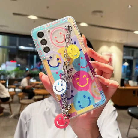 a person holding up a phone case with a colorful pattern