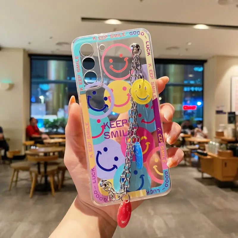 a person holding up a phone case with a colorful pattern