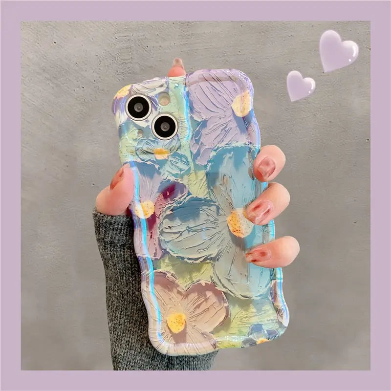 a person holding a phone case with a painting on it