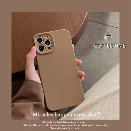 a person holding a phone case with a coffee cup