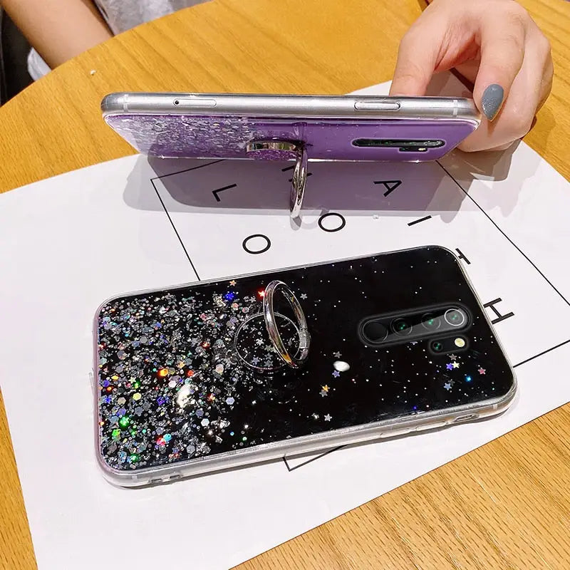 a person is holding a phone case with glitter