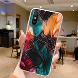 a person holding up a phone case with a colorful marble pattern