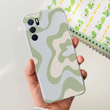 a person holding a phone case with a camouflage pattern