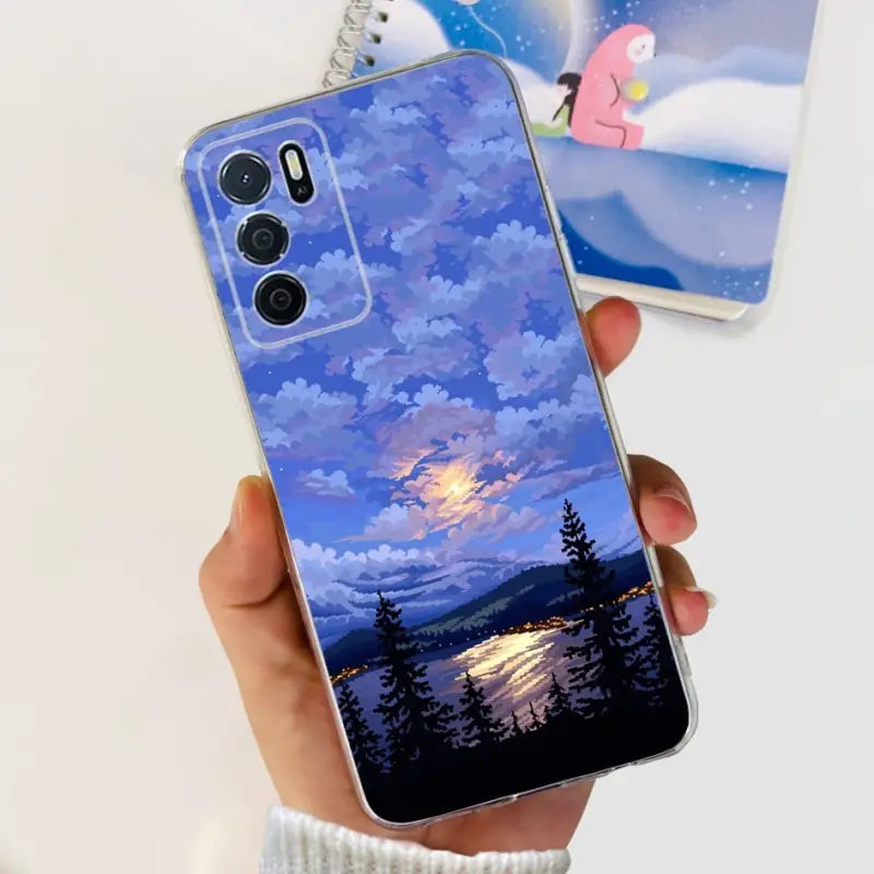 a person holding a phone case with a painting of a sunset