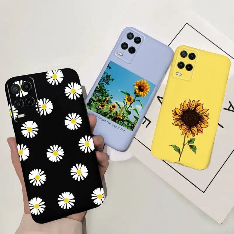 a person holding a phone case with a sunflower design