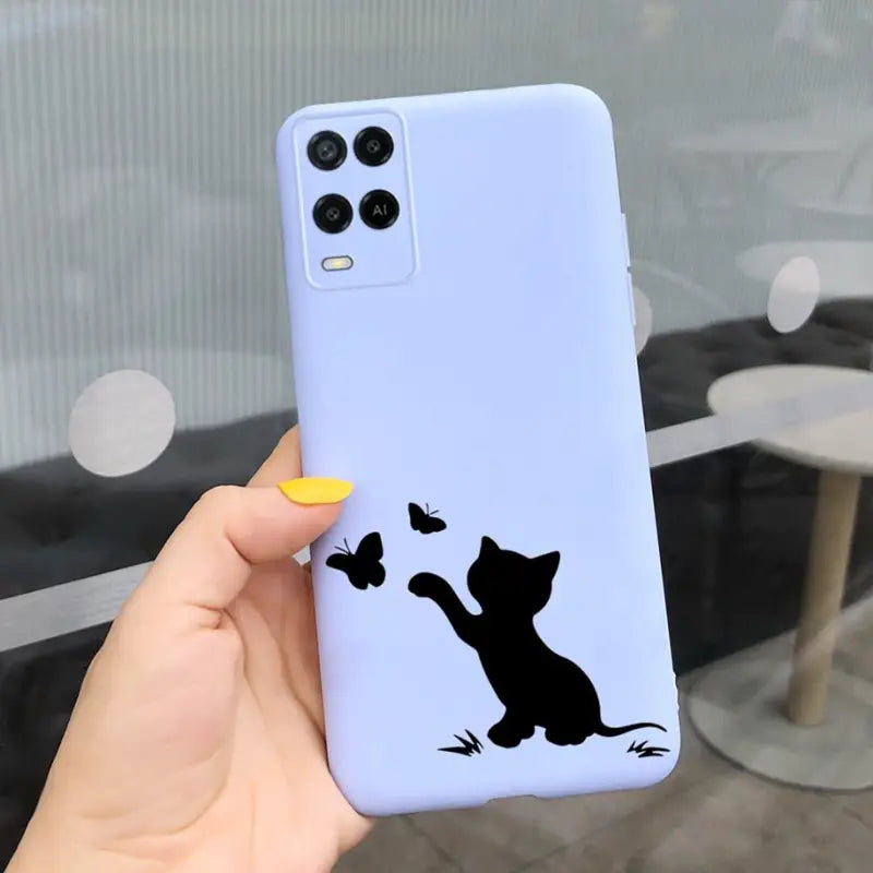 a person holding a phone case with a cat silhouette