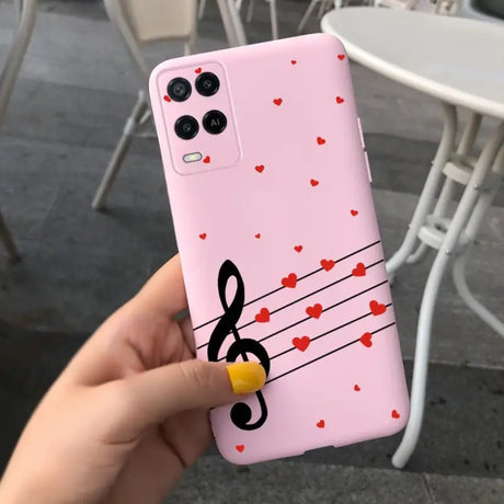 a person holding a phone case with music notes