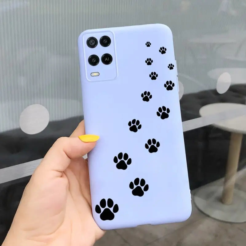 a person holding a phone case with paw prints