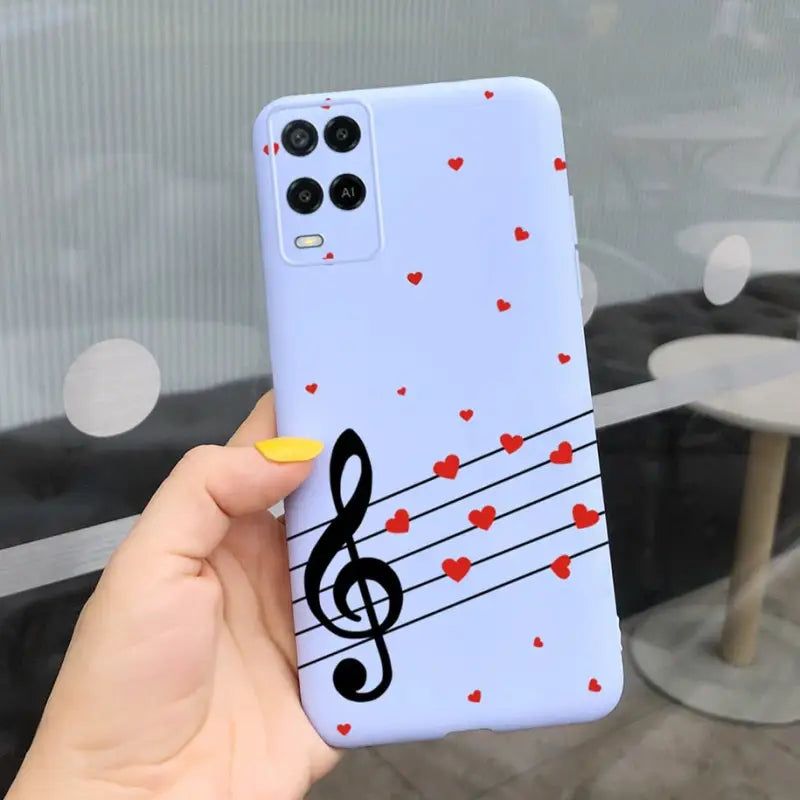 a person holding a phone case with music notes