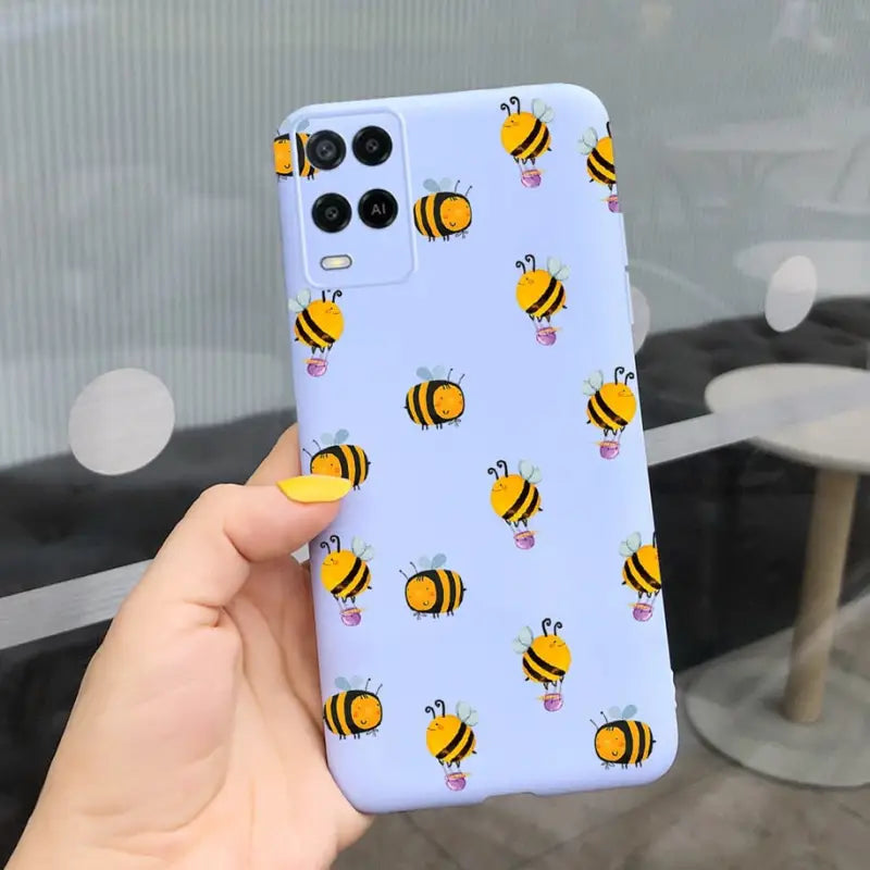 a person holding a phone case with bees on it