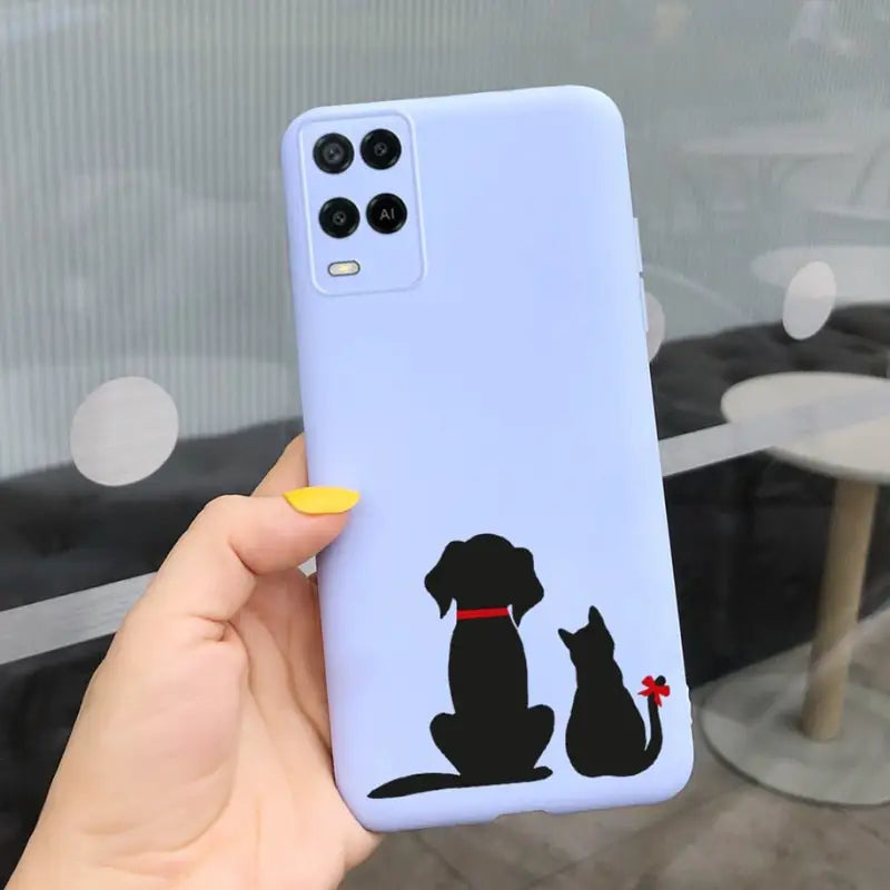 a person holding a phone case with a dog and cat