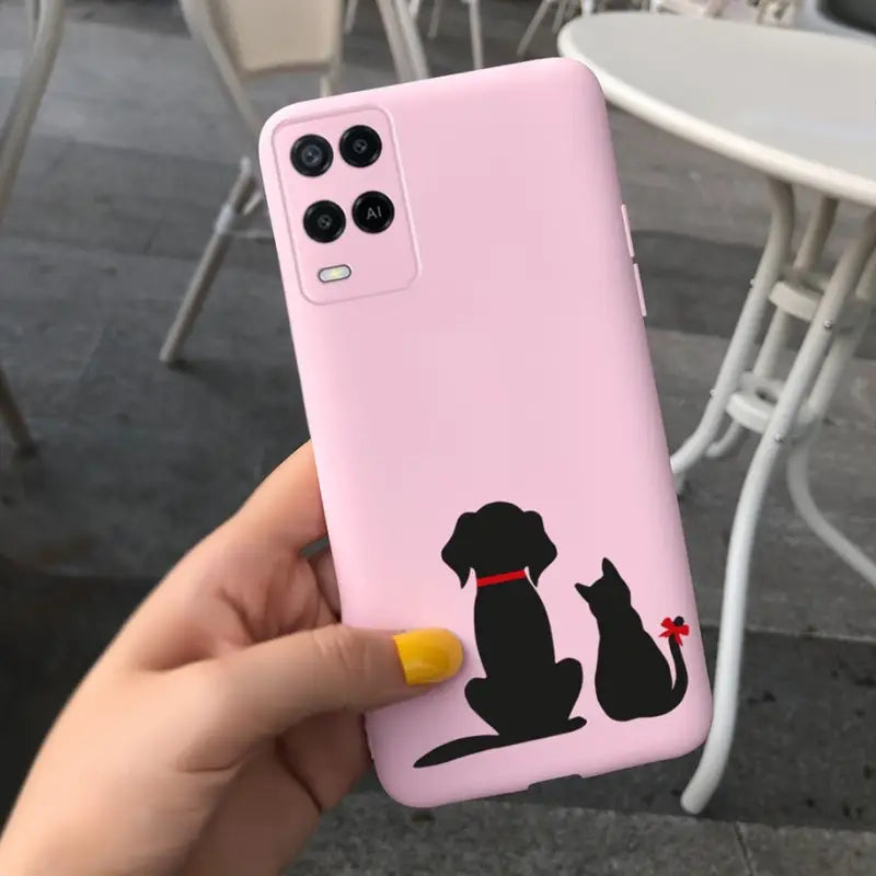 a person holding a pink phone case with a black dog on it