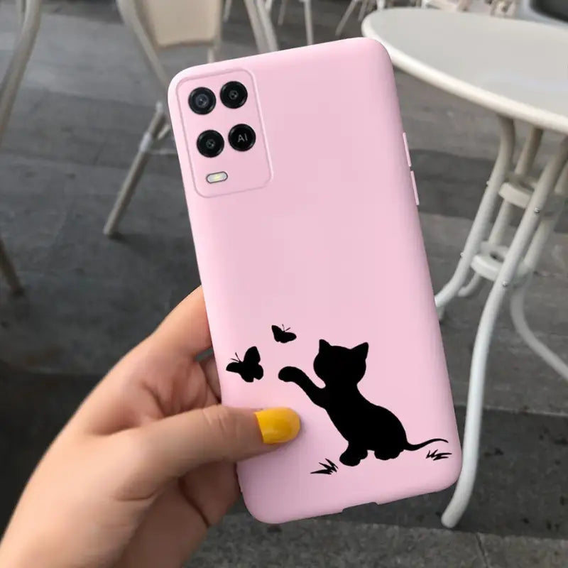 a person holding a pink phone case with a cat on it