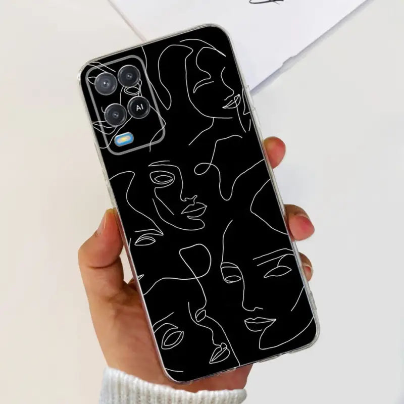 a person holding a phone case with a black and white drawing of a face