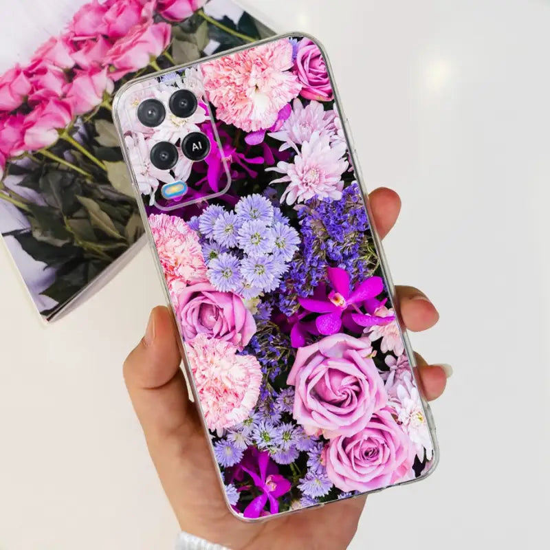 a person holding a phone case with flowers on it