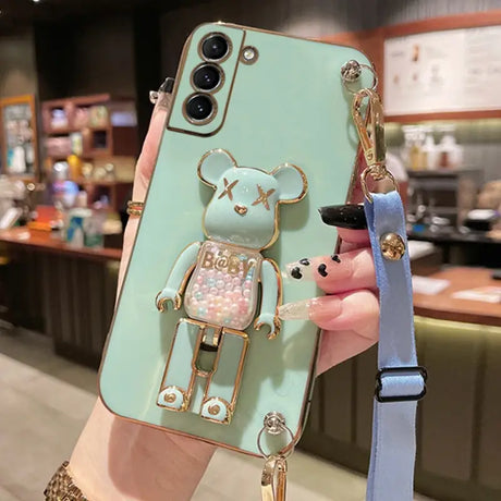 a person holding a phone case with a bear