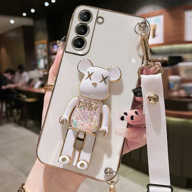 a person holding a phone case with a bear
