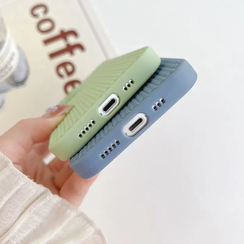 a hand holding a phone case with a green and blue phone cover