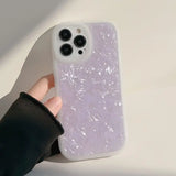 a person holding a phone case with a purple liquid