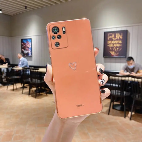 a person holding up a pink iphone case